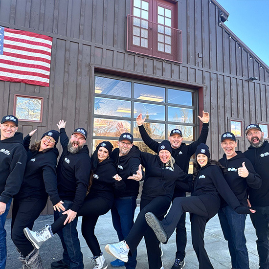 The Fence Company truck wrapped with company branding parked outside the Fence Company work shop