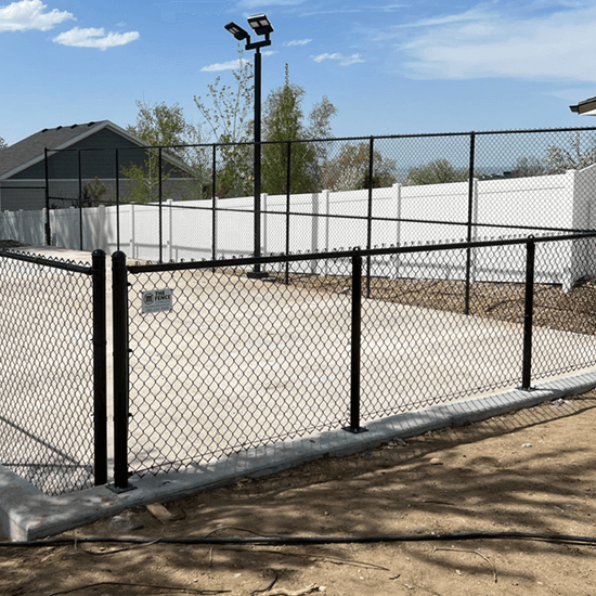 Commercial black PVC-coated chain link fence installation