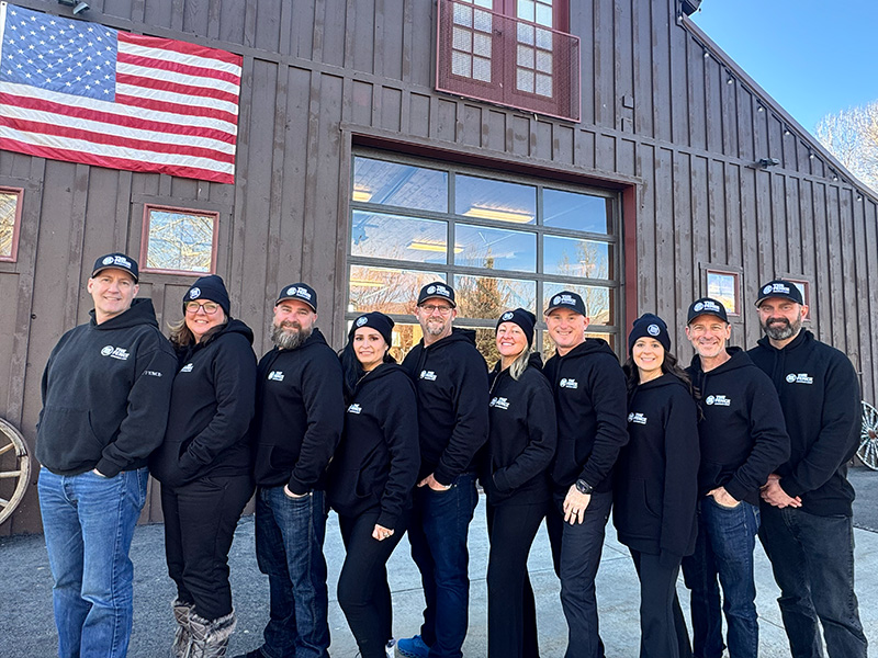 The Fence Company standing in front of their main office