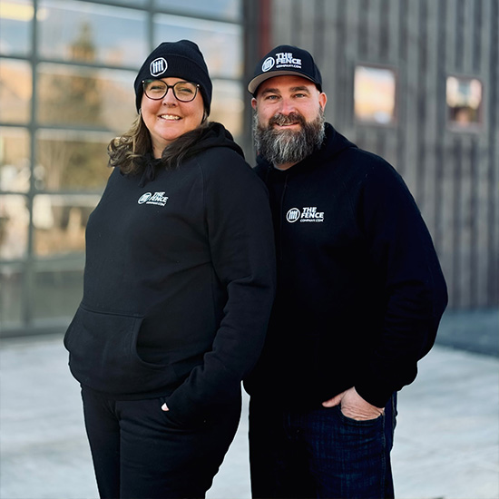 The Fence Company owners standing in their fence showroom